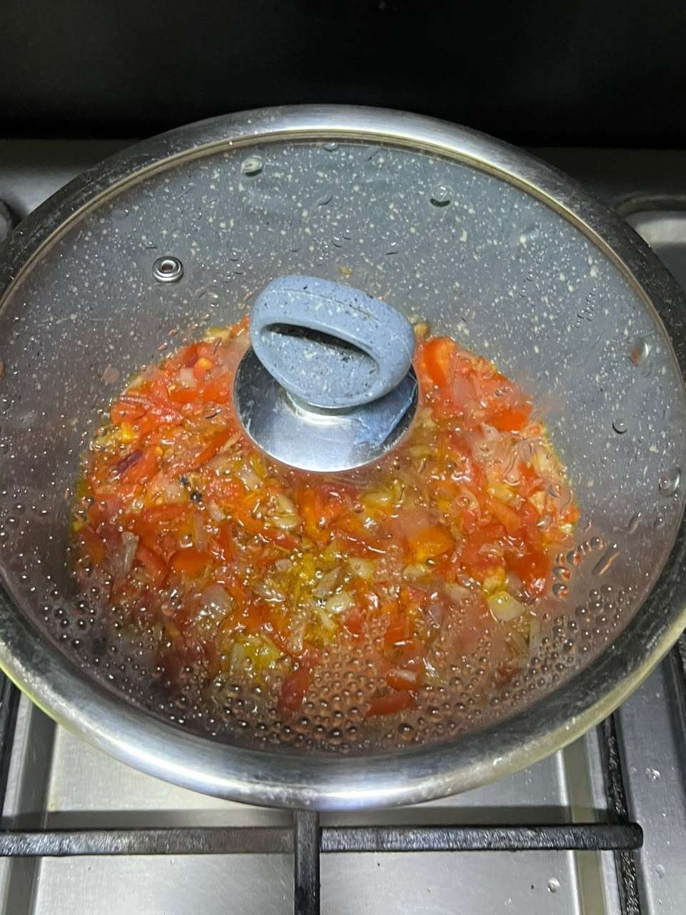 Tomatoes cooking until soft and mushy.