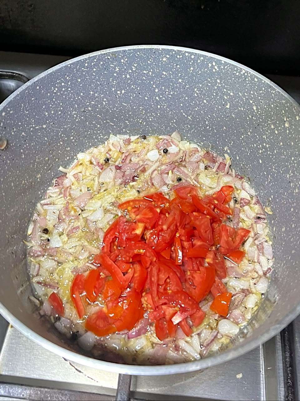 Fresh chopped tomatoes added to the onion mixture.