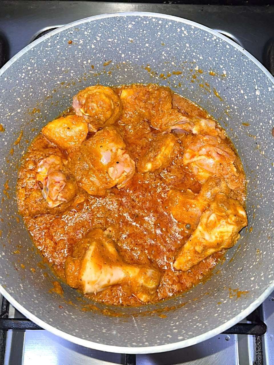 Chicken coated with the cooked curry masala.