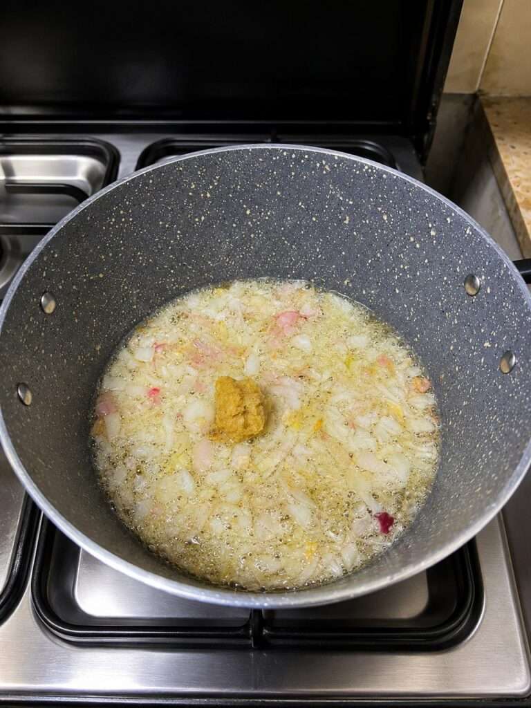 Chopped onions and ginger garlic paste sautéing in oil
