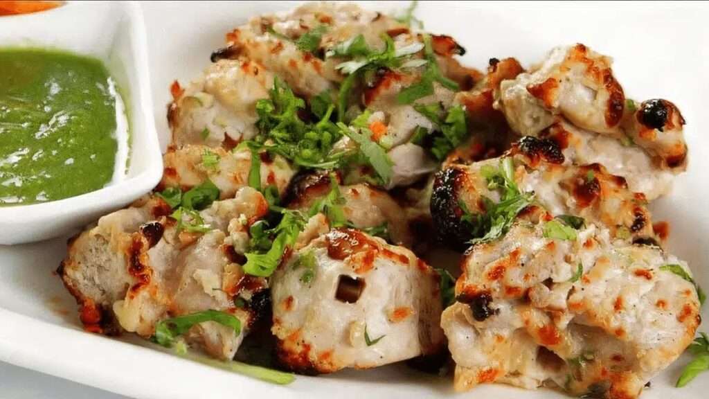 Close-up of juicy Chicken Malai Tikka with creamy coating and charred edges.