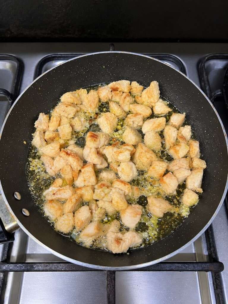 Golden brown boneless chicken pieces fried in oil and ginger garlic paste