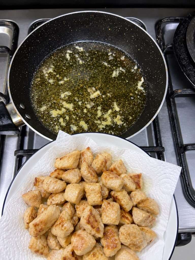 Golden fried chicken pieces placed on a plate after sautéing