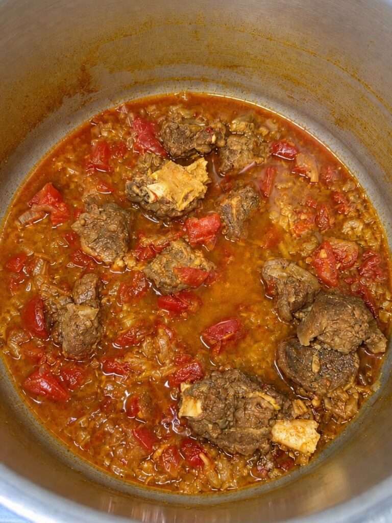 Tender cooked meat with tomatoes and spices after pressure cooking